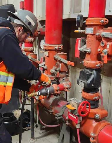 Technician working on a fire-protection piping installation